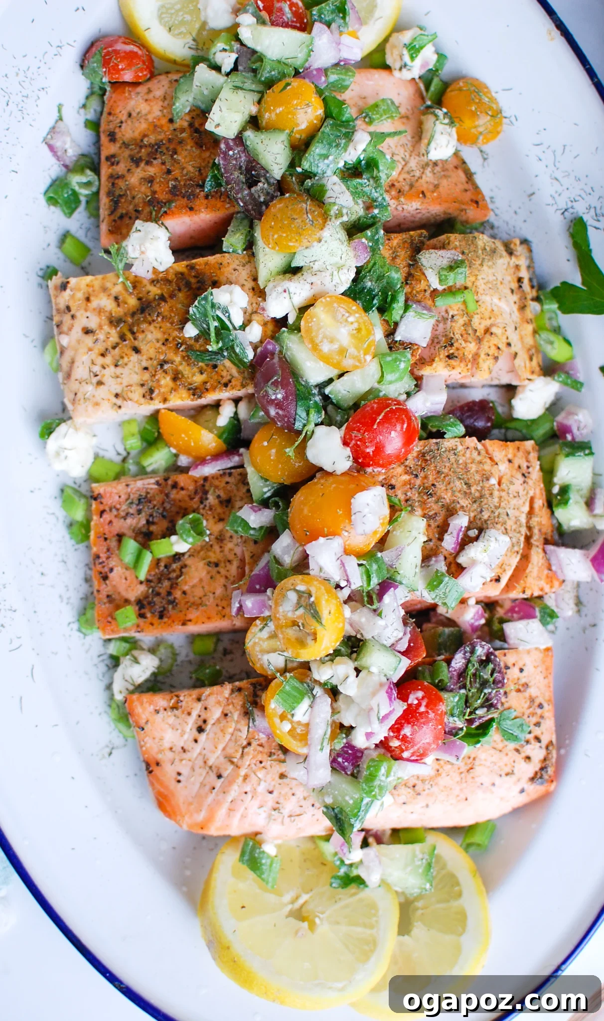 Sun-Kissed Mediterranean Baked Salmon 7 a platter with fish and fresh vegetables on top.
