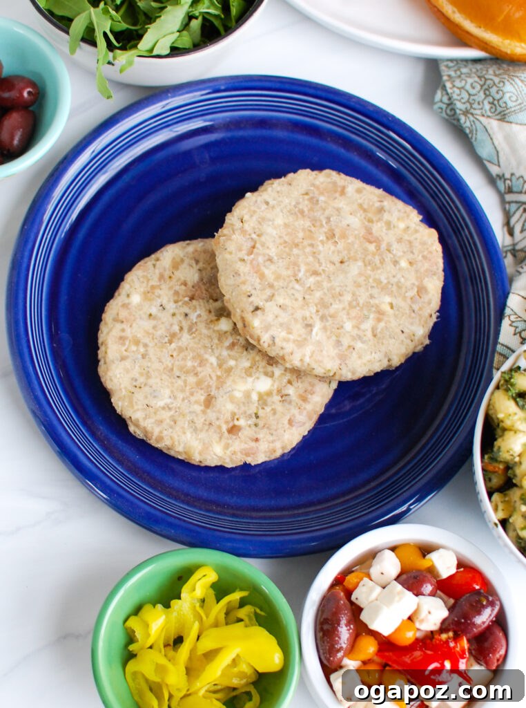 Zesty Greek Chicken Burgers 5 Plated Greek Chicken Burgers with a variety of fresh toppings