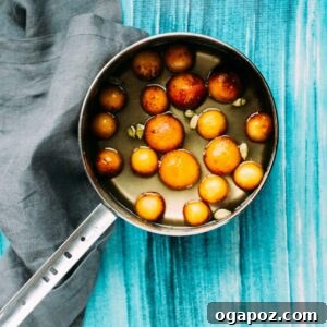 Gulab Jamun in syrup on the stove.