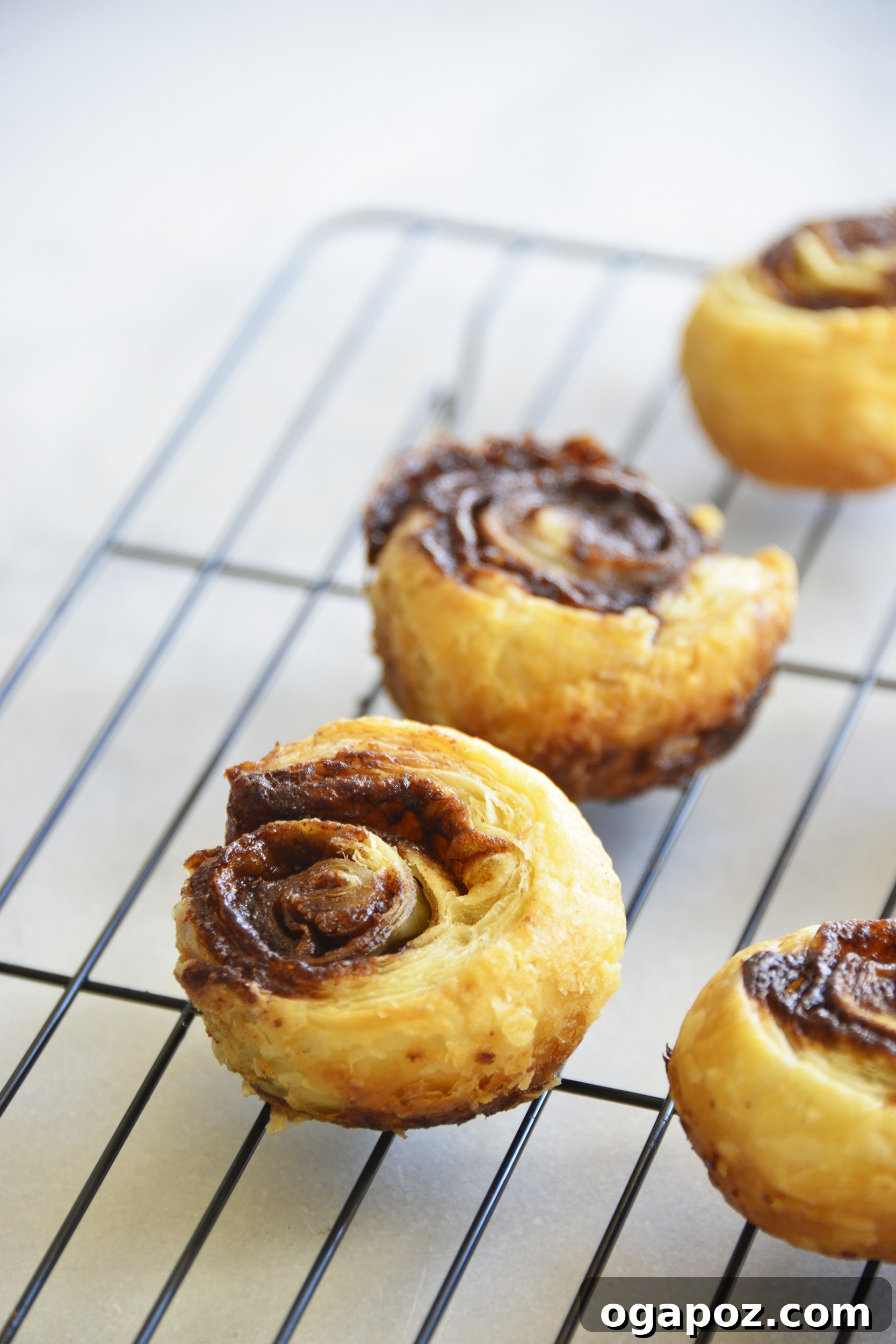 Effortless Cinnamon Puff Pastry Swirls 4 Baked Easy Puff Pastry Cinnamon Swirls fresh from the oven, resting on a baking sheet, showcasing their beautiful golden color.