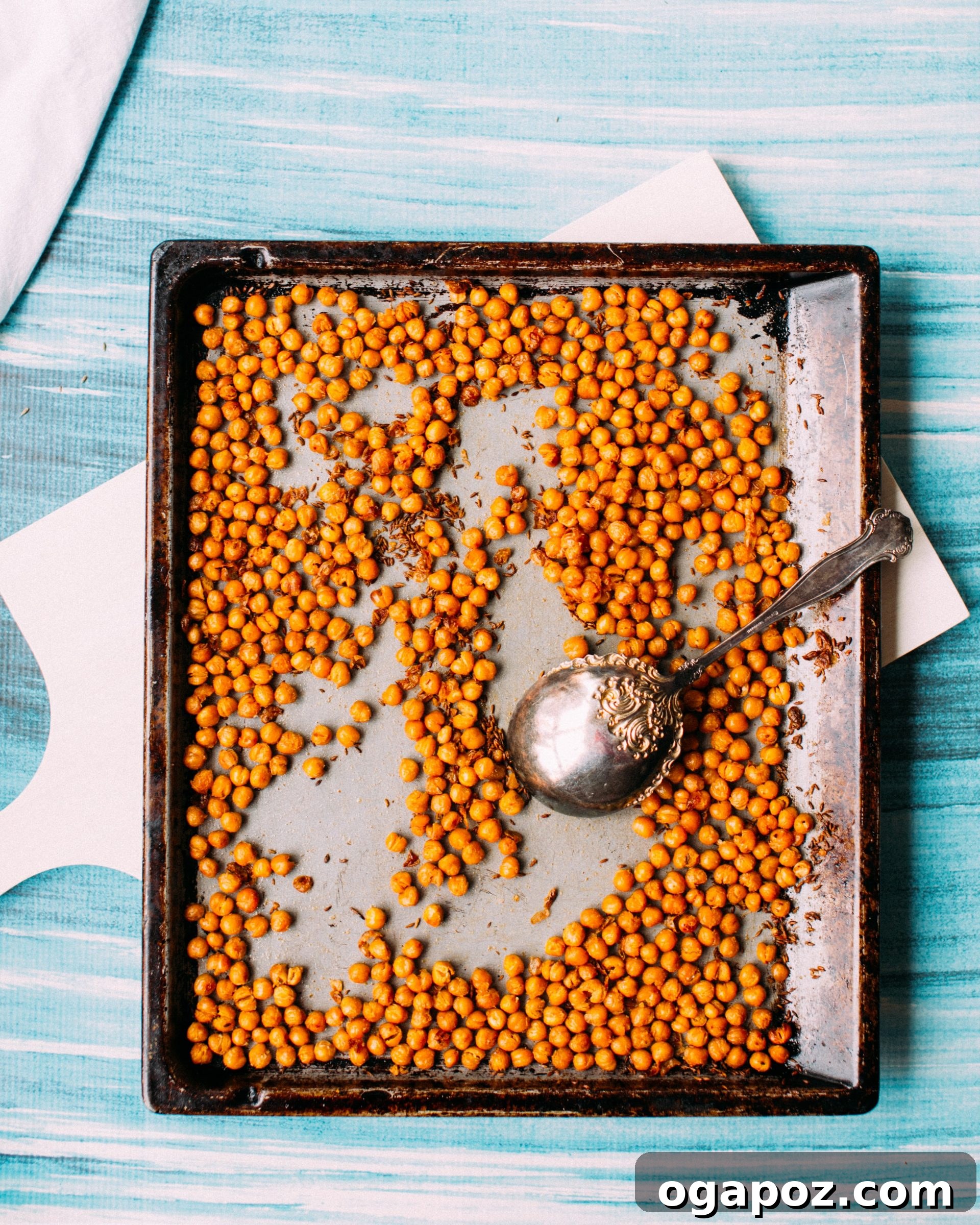 A serving of Spiced Roasted Chickpeas on a rustic wooden board.