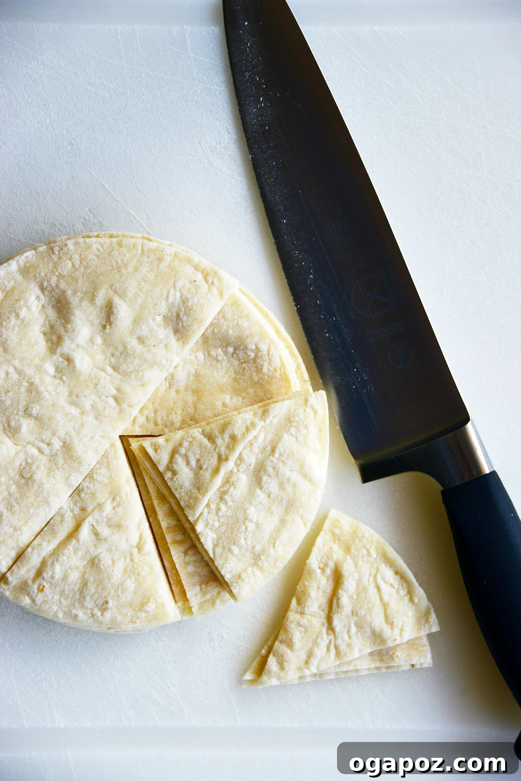 The Art of Homemade Tortilla Chips 4 Corn tortillas neatly cut into triangular wedges, ready for seasoning.