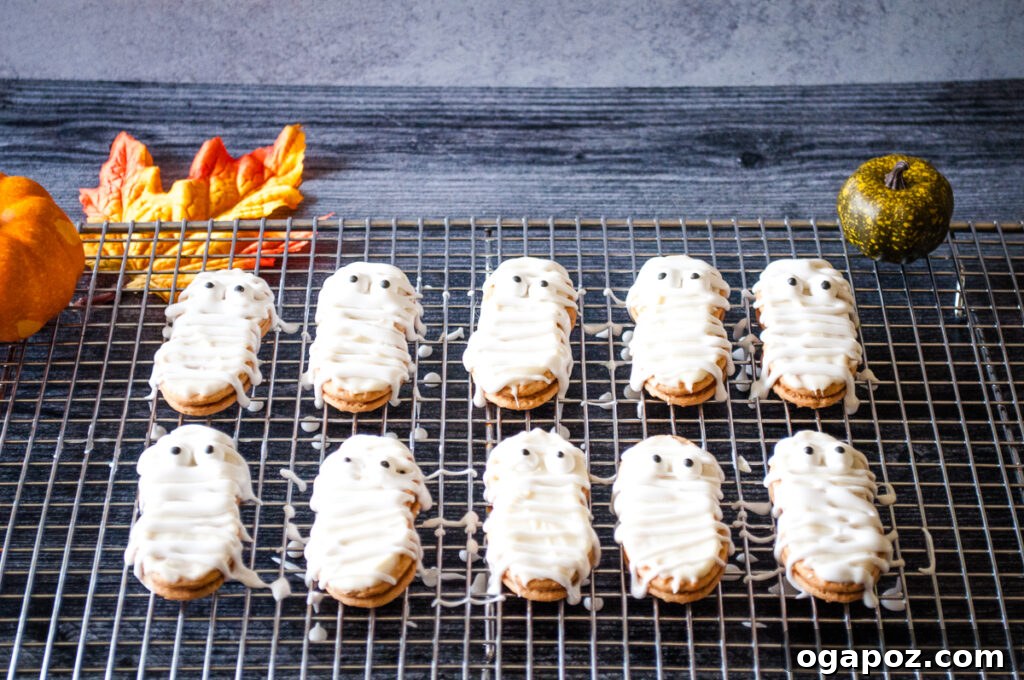 Spooky Mummy Cookies 7 Finished Mummy Cookies drying on a wire rack, complete with white frosting bandages