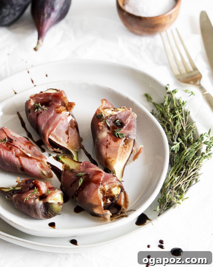 Fig & Goat Cheese Jewels Wrapped in Prosciutto 7 A Goat Cheese Fig Wrapped in Prosciutto on a fork, ready to be eaten