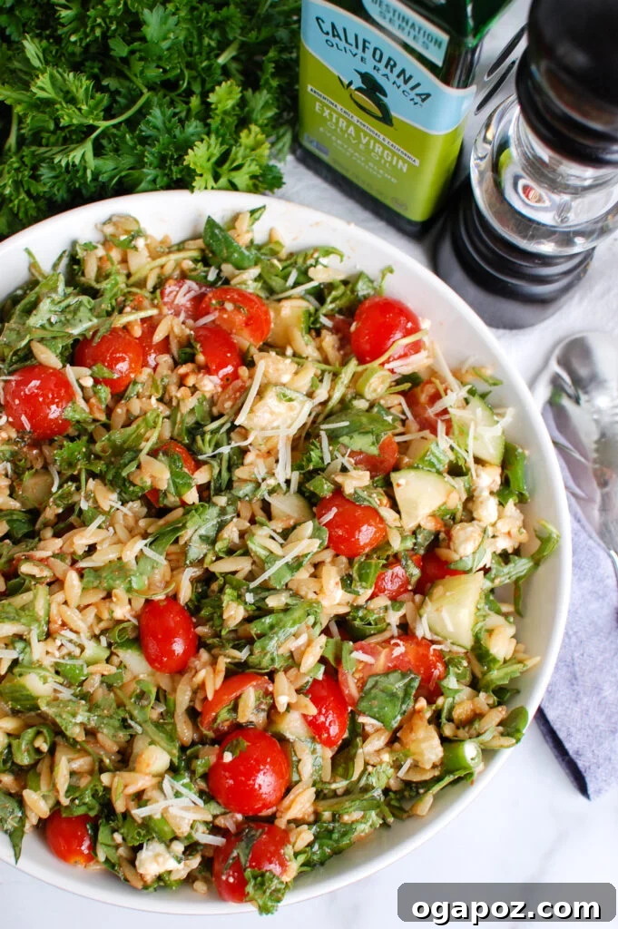 Vibrant Tomato Feta Orzo Salad 4 Tomato Feta Orzo Salad served elegantly with a napkin, showcasing its fresh and appetizing appeal.