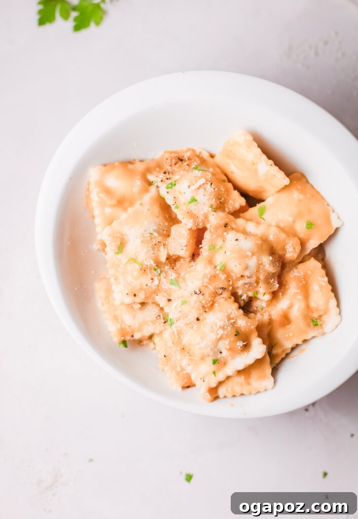 Brown Butter Sage Pumpkin Ravioli 3 Creamy Pumpkin Ravioli spread out on a white mat, ready to be served, showcasing its vibrant color and texture.