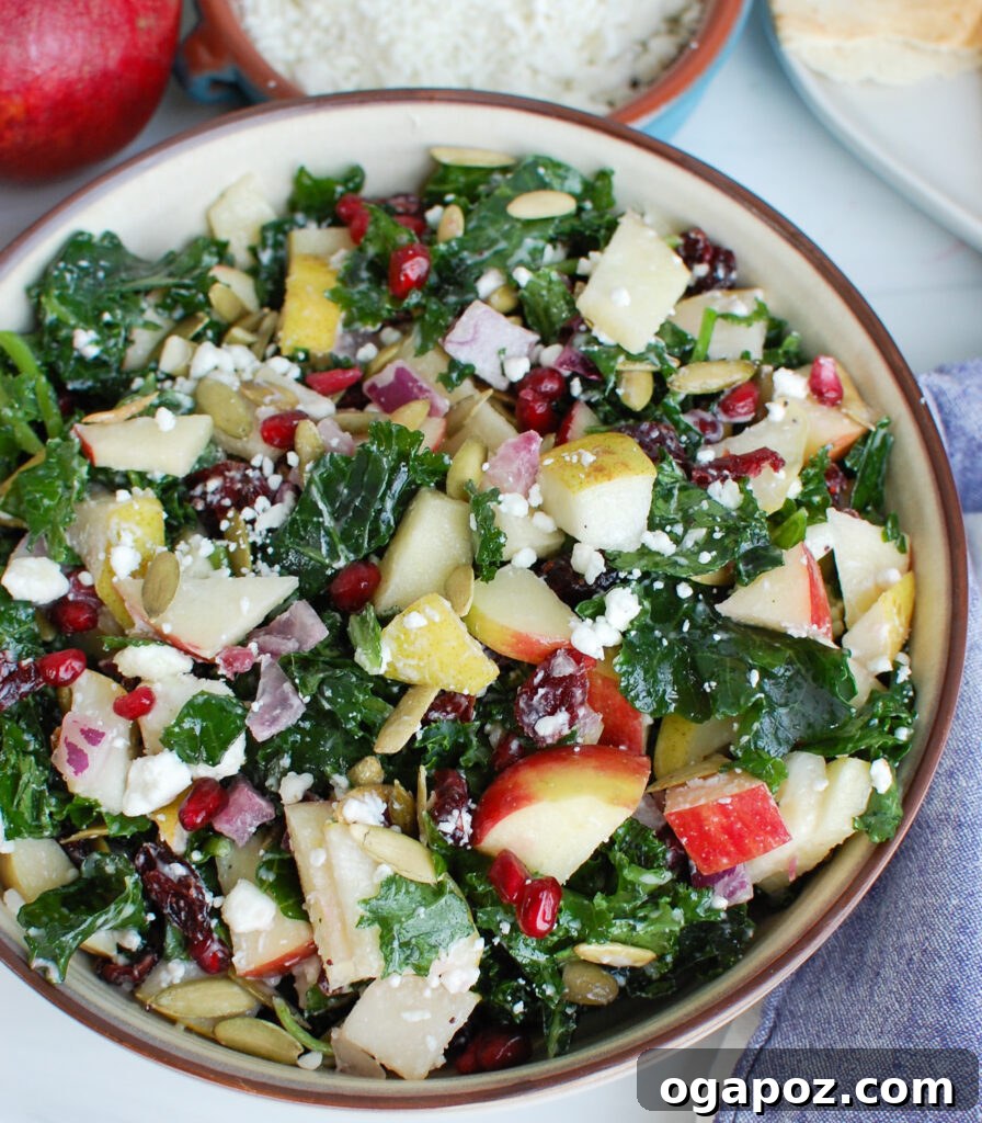 Crisp Autumn Harvest Salad 6 Easy Fall Salad topped with fresh pomegranate seeds in a white bowl