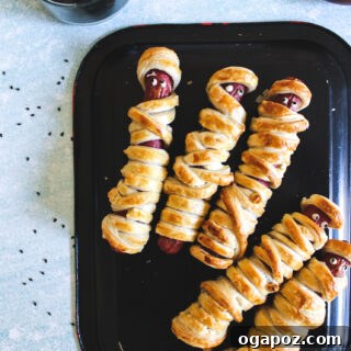 Mummy Hot Dogs on black plate