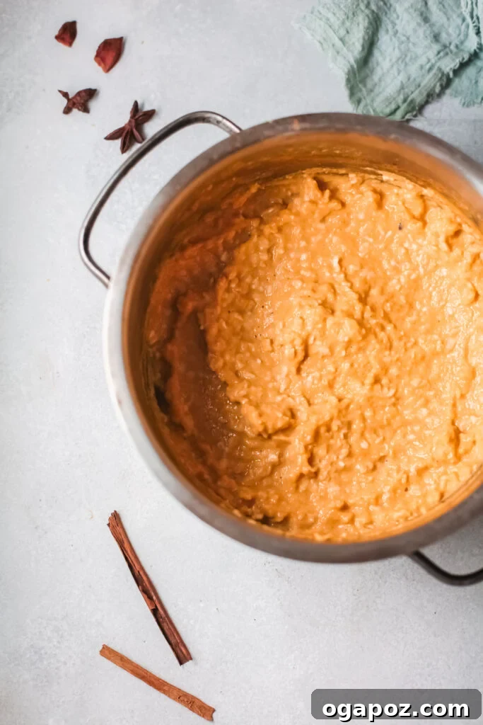 Cozy Pumpkin Oatmeal 3 A large pot filled with creamy pumpkin oatmeal, showing its inviting texture and warm color, ready to be served.