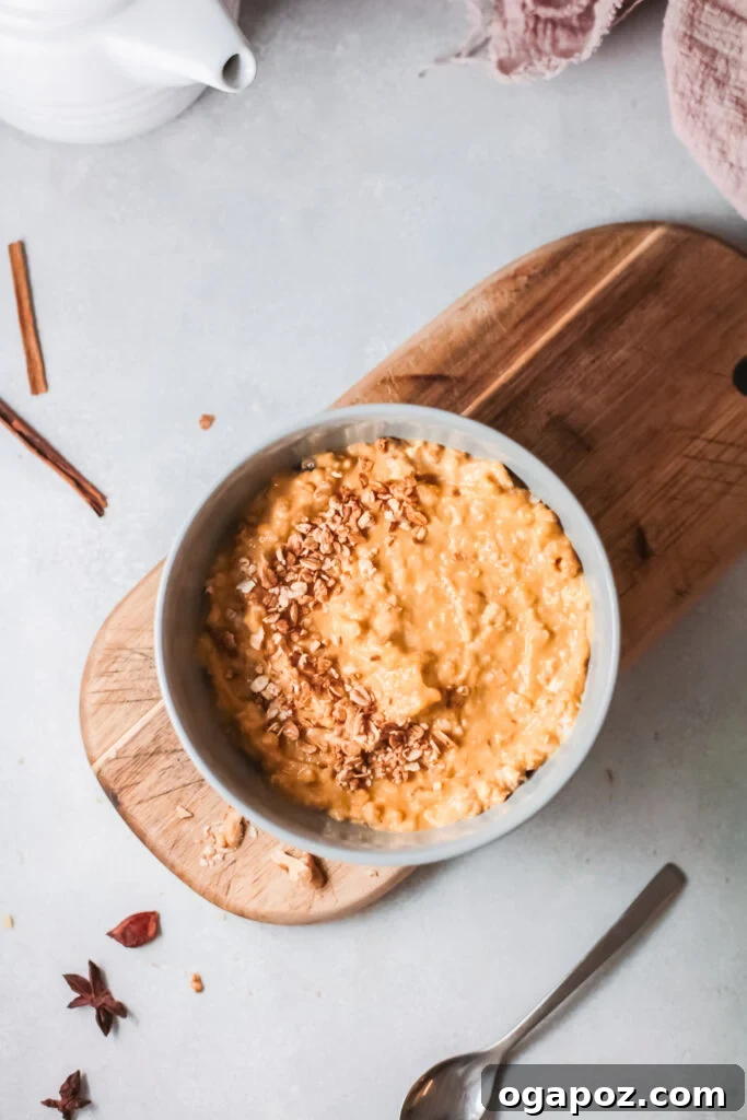 Cozy Pumpkin Oatmeal 4 Easy Pumpkin Oatmeal beautifully presented on a wooden board, showcasing its rich, creamy texture and warm fall colors, inviting a comforting breakfast.