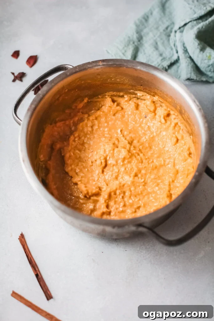 Cozy Pumpkin Oatmeal 7 A close-up of the delicious pumpkin oatmeal in a pot, freshly cooked and ready to be scooped into serving bowls, promising a warm, comforting meal.