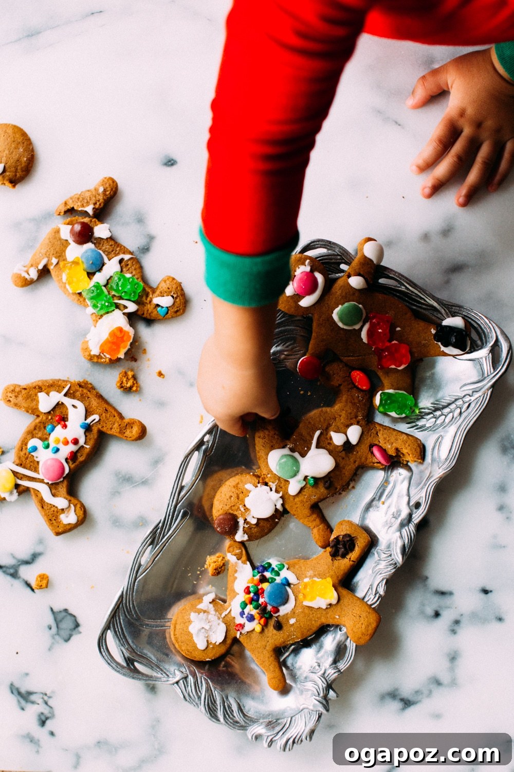 Melt-in-Your-Mouth Chewy Gingerbread 3 A child's hands decorating gingerbread men cookies