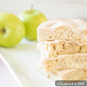 A charming image of Apple Bars with Pumpkin Pie Spice Icing on a plate, ready to be served and enjoyed as a delicious fall dessert.