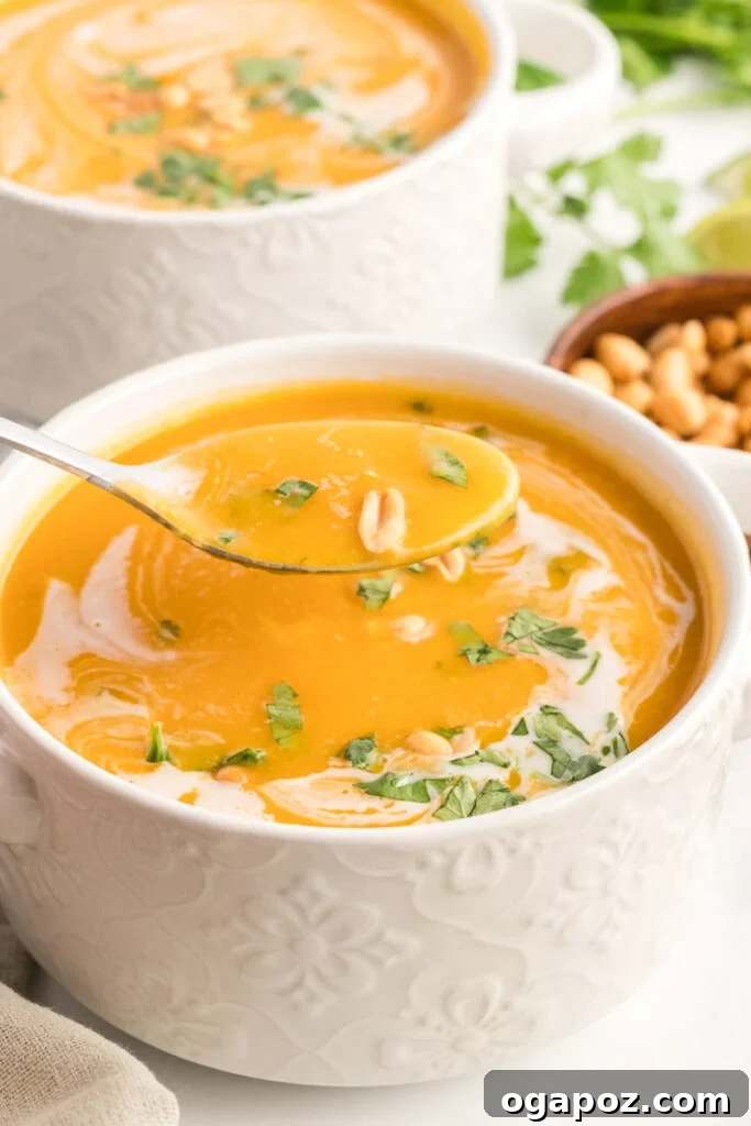 Instant Pot Butternut Squash Soup with a spoon, ready to be eaten