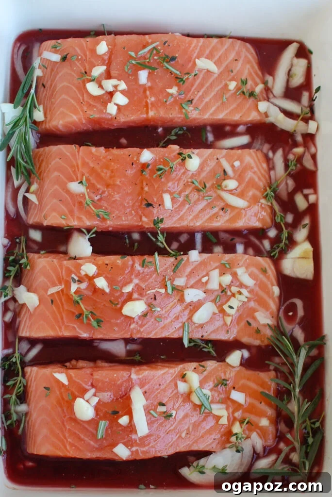 Jeweled Pomegranate Salmon 5 Honey Glazed Pomegranate Salmon in a pan, just out of the oven, with herbs