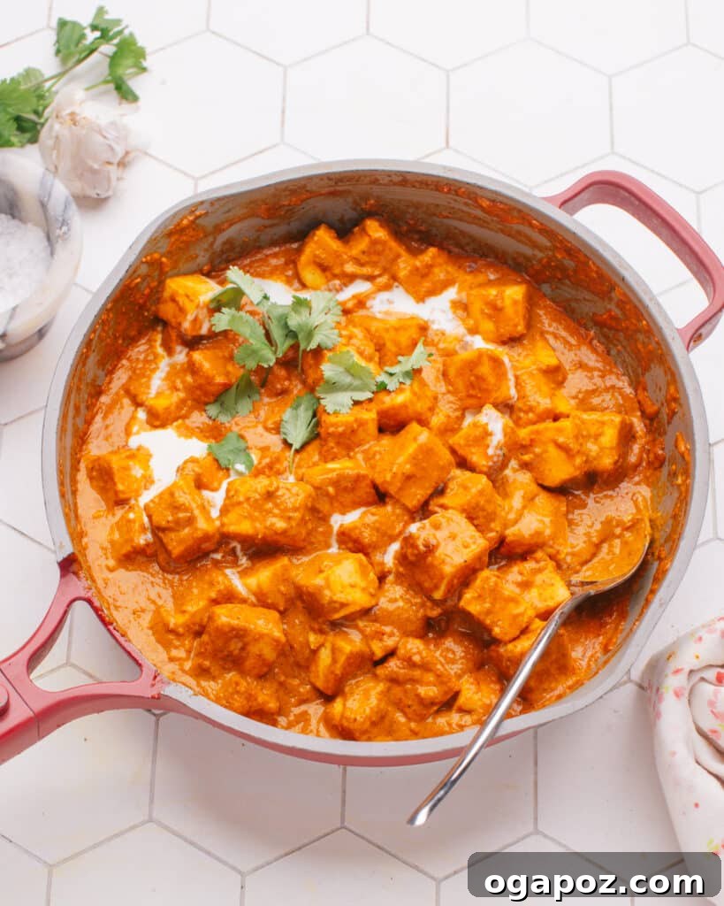 Crafting Perfect Paneer A Home Kitchen Guide 11 A rich, creamy Butter Paneer dish served in a pan, showcasing the deliciousness of homemade paneer.