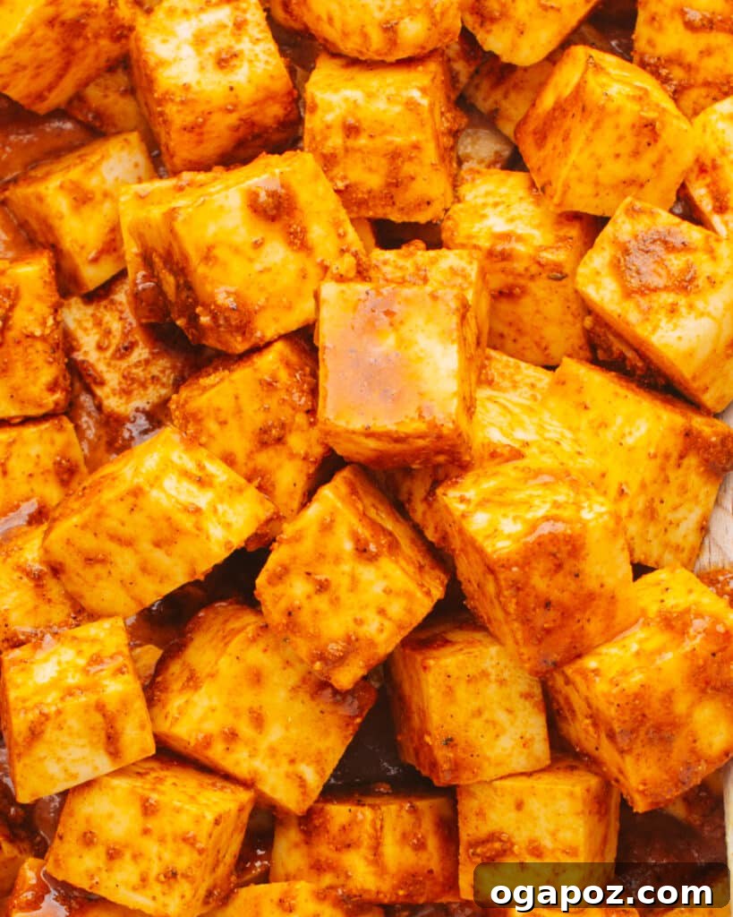 Crafting Perfect Paneer A Home Kitchen Guide 10 Paneer cubes being marinated in a bowl, showing a preparatory step before cooking.