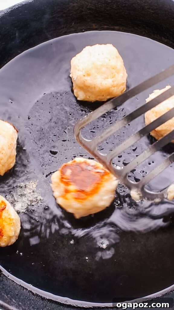 Effortless Creamy Paneer Kofta Curry 11 Pan-frying the paneer kofta balls in a skillet until golden.
