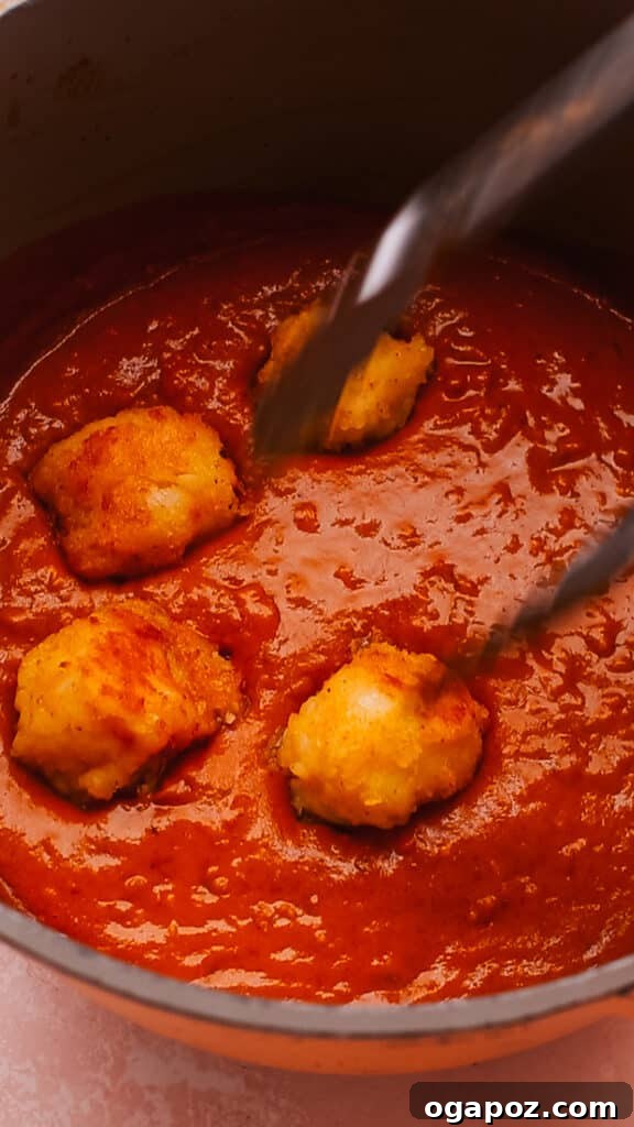 Effortless Creamy Paneer Kofta Curry 12 Adding pan-fried kofta balls to the creamy curry sauce.
