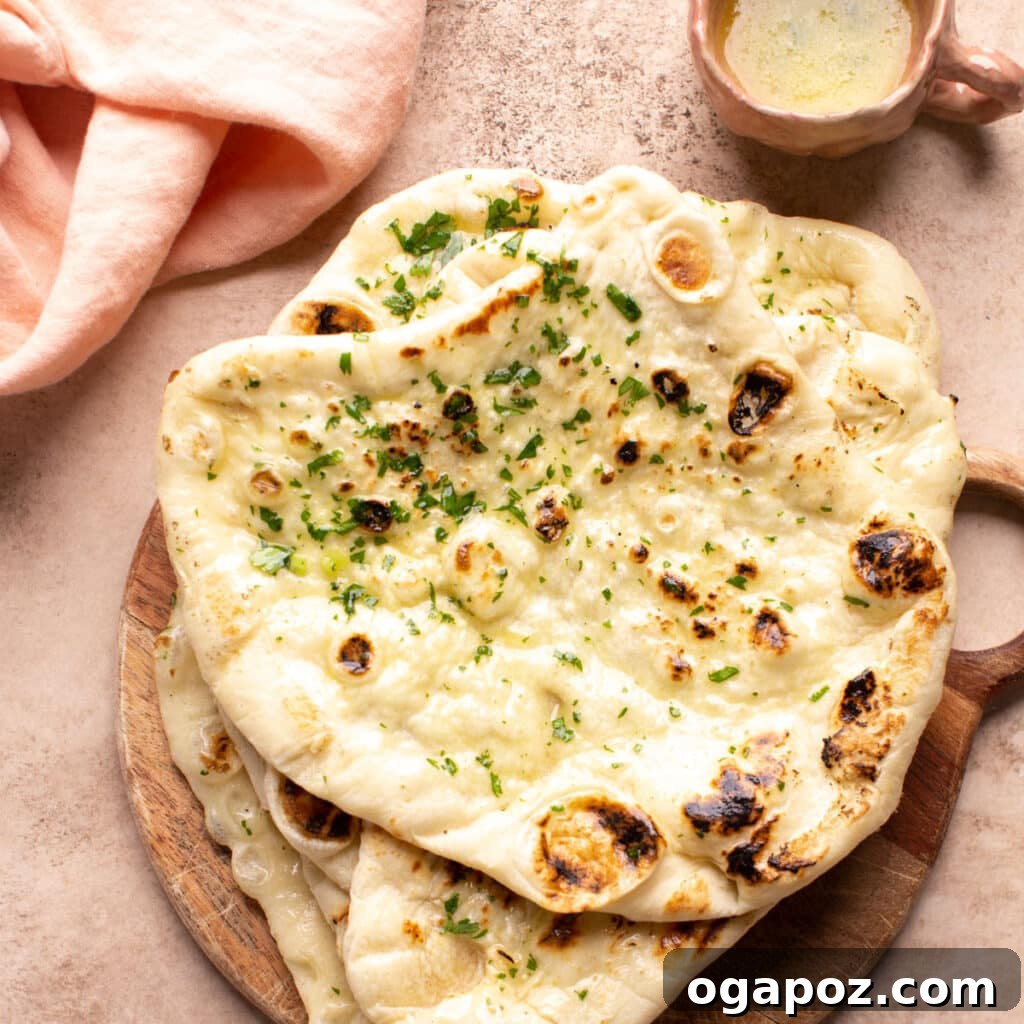Effortless Creamy Paneer Kofta Curry 15 Warm butter naan bread with a small dish of melted butter.