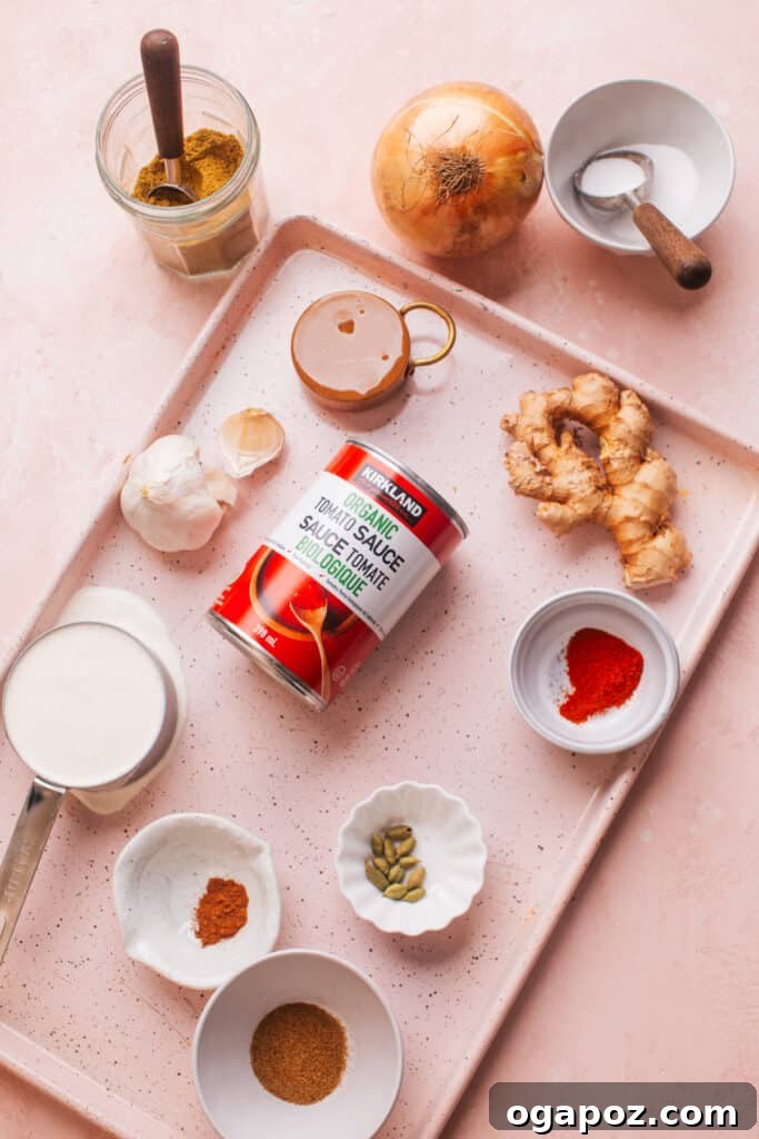 Effortless Creamy Paneer Kofta Curry 5 Assorted ingredients for Malai Kofta laid out on a tray, including spices, onions, and paneer.