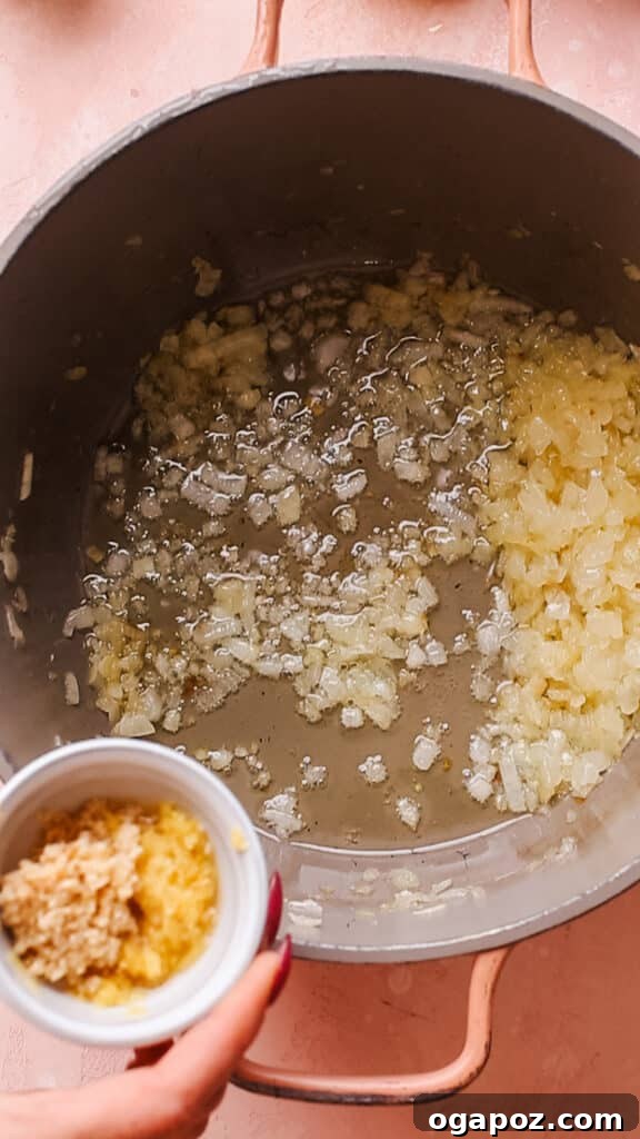 Effortless Creamy Paneer Kofta Curry 7 Cooking onions, garlic and ginger for the Malai Kofta gravy in a pan.