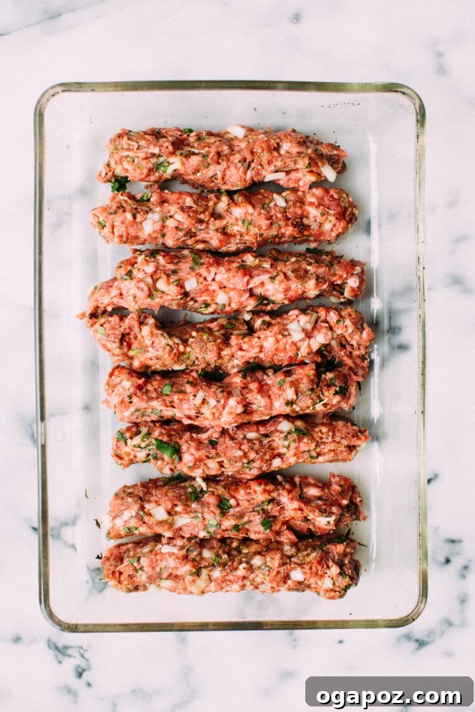 Creamy Tahini Lamb Kofta 3 Close-up of perfectly baked Lamb Koftas submerged in a golden tahini sauce