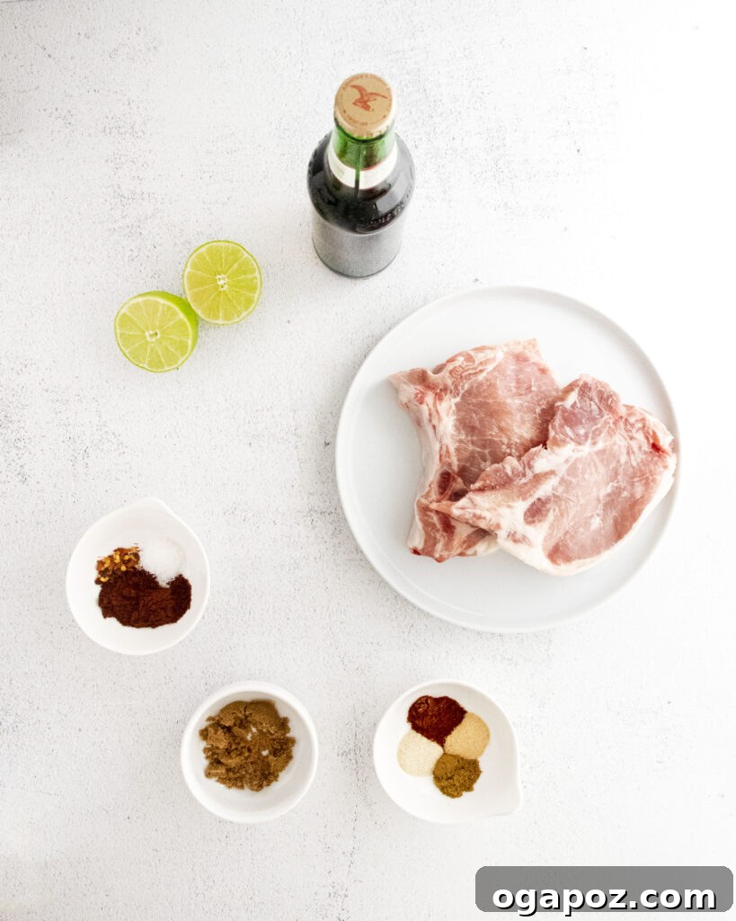 Tender and Crispy Instant Pot Carnitas 3 A selection of fresh ingredients including pork chops, spices, lime, and beer, laid out for Instant Pot Carnitas.