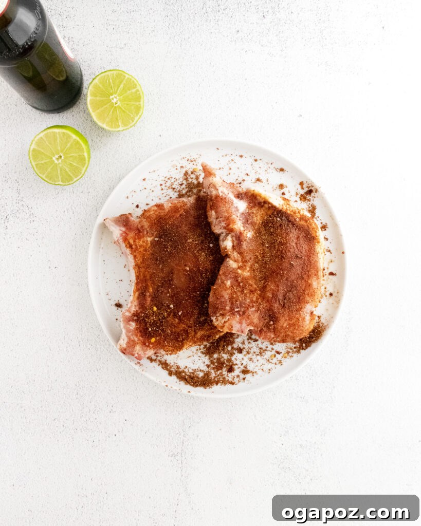 Tender and Crispy Instant Pot Carnitas 5 Pork chops coated in spice rub, ready for searing for Instant Pot Carnitas.