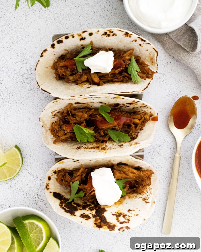 Tender and Crispy Instant Pot Carnitas 8 Crispy Instant Pot Carnitas arranged in a taco holder, ready to be filled for serving.