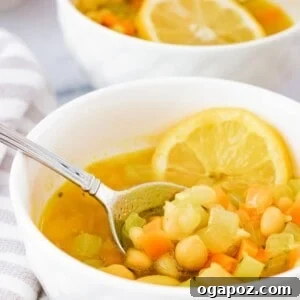 Easy Vegetable Bean Soup in a rustic white bowl, garnished with fresh herbs.