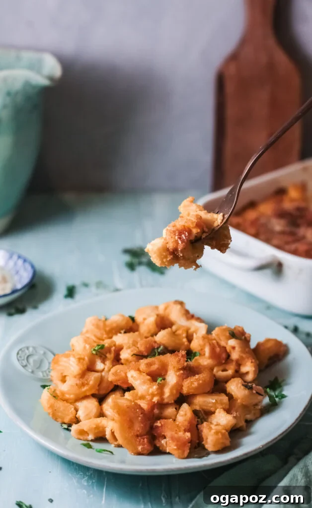 Velvet Pumpkin Mac and Cheese 3 Pumpkin Mac and Cheese with a fork taking a bite
