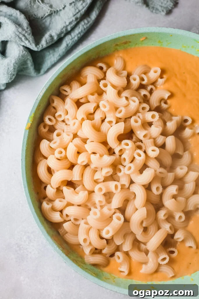 Velvet Pumpkin Mac and Cheese 6 Creamy pumpkin sauce thickening in a dish