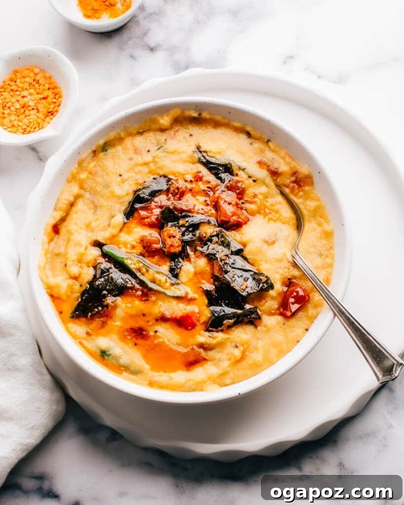 Flavorful Indian Vegetarian Dinner Ideas 3 Vibrant Masoor Dal (red lentil curry) presented in a bowl with a traditional tadka seasoning, accompanied by a spoon.