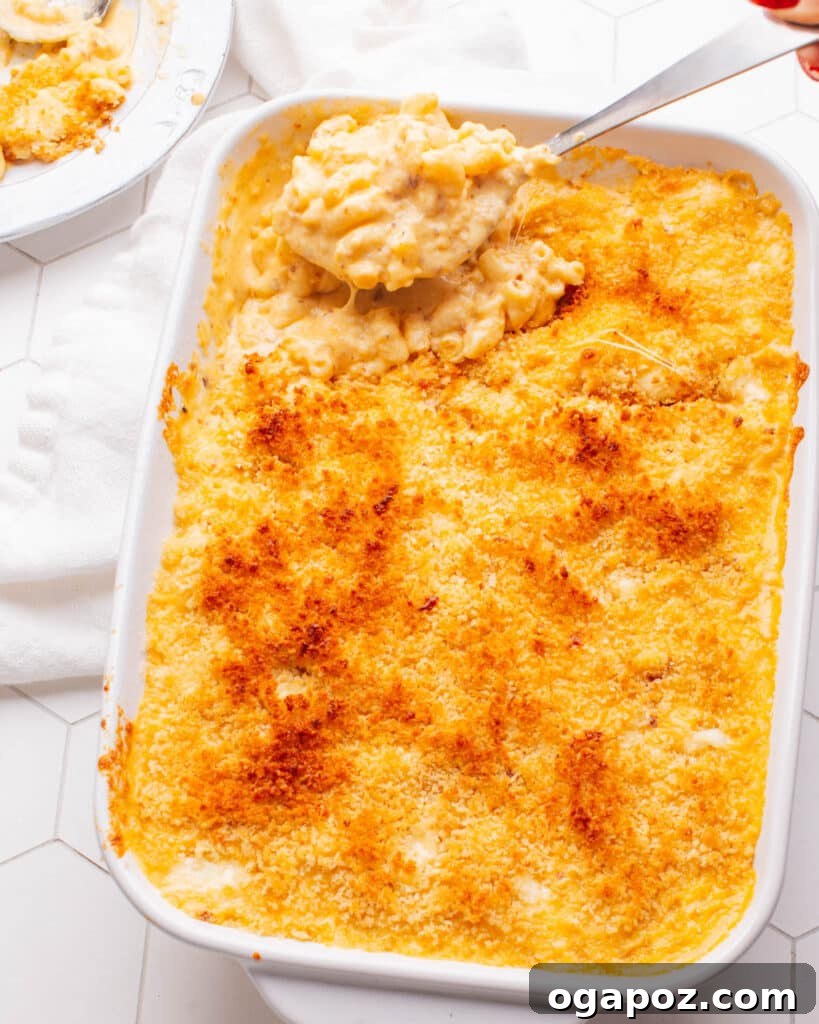 Elevate Your Wing Meal Side Dish Ideas 16 A serving spoon scooping out a generous portion of creamy Old Fashioned Baked Macaroni and Cheese.