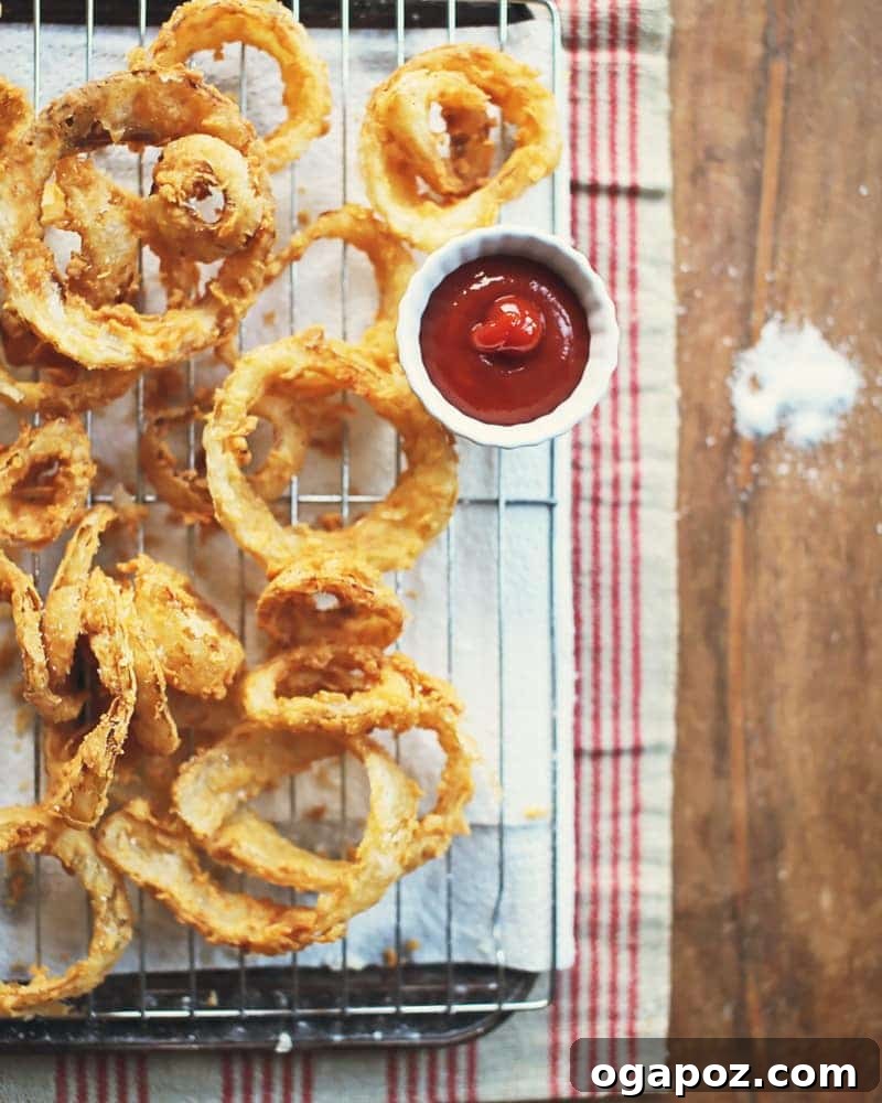 Elevate Your Wing Meal Side Dish Ideas 22 Piled high, light and crispy homemade onion rings ready to eat.