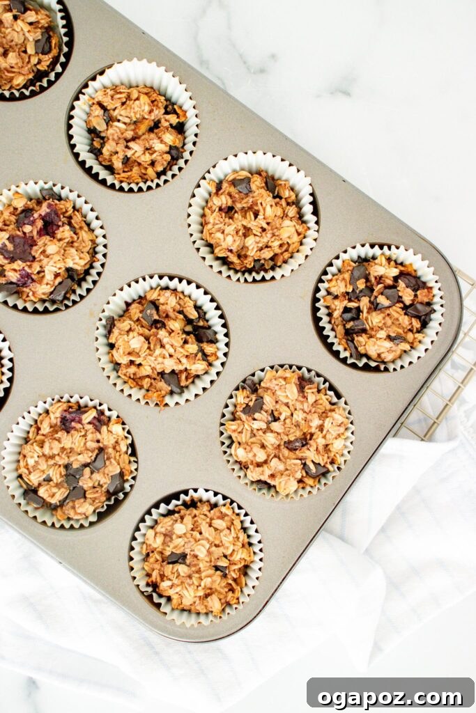 Golden Banana Oat Goodness 3 Warm Banana Oatmeal Muffins still in the muffin tin, ready to be enjoyed