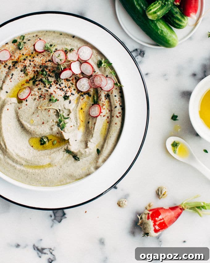 Black Tahini Hummus 4 A vibrant green plant or garden, symbolizing the 'grass is greener' sentiment and the allure of connecting with nature, even in an urban setting.