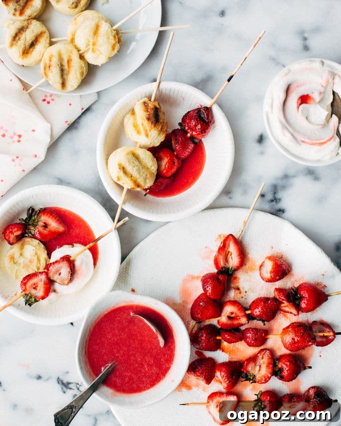 Flame-Kissed Strawberry Shortcake Sticks 5 Grilled biscuits with golden brown marks, ready to be assembled into strawberry shortcake kebabs.