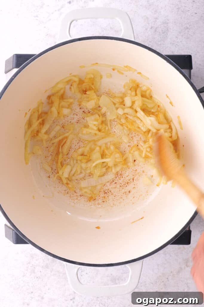 Fiery Goan Pork Vindaloo 4 Slicing onions, an essential step for the aromatic base of the Pork Vindaloo Curry.