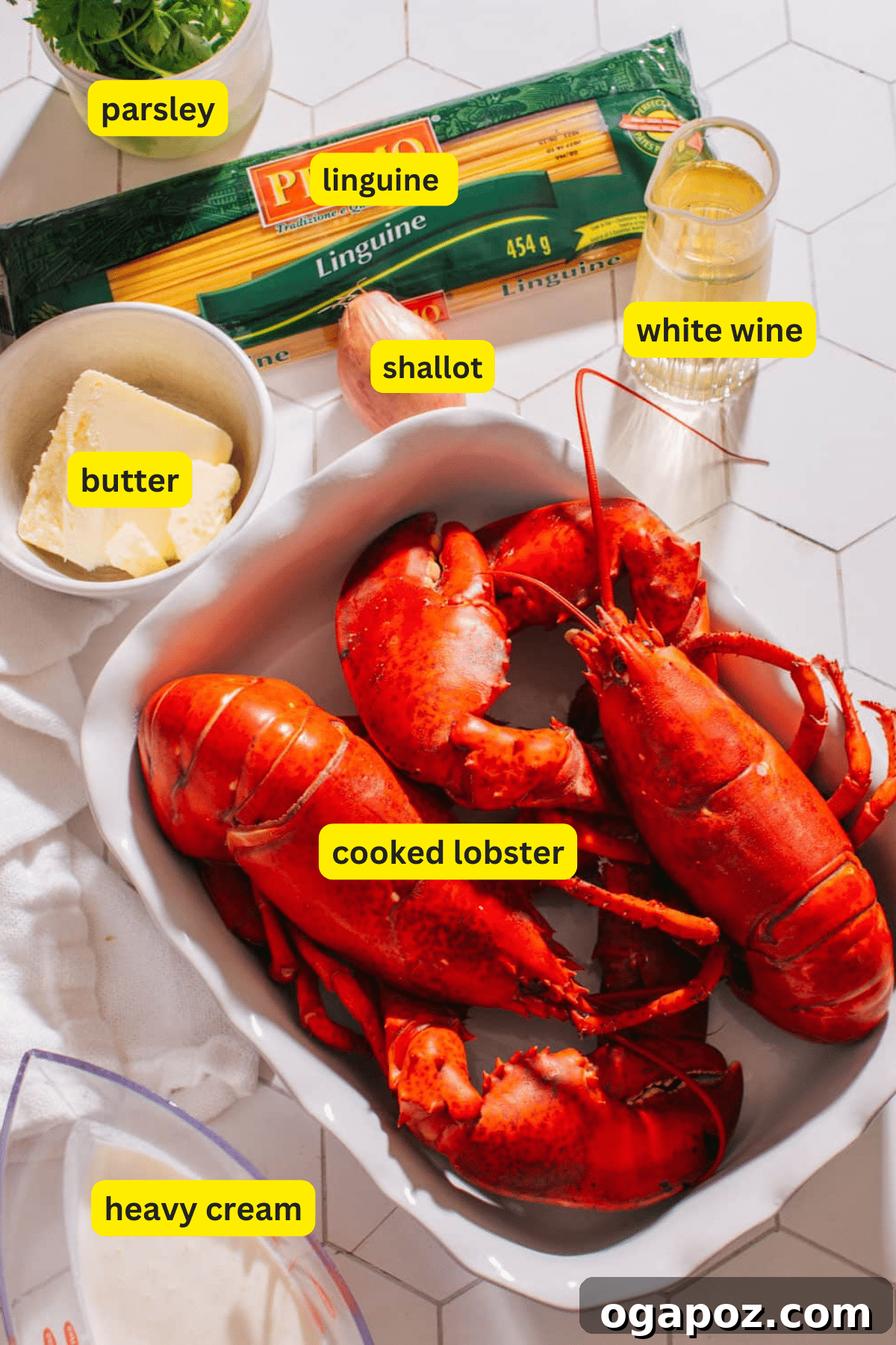 Luxurious Lobster Pasta with White Wine Cream Sauce 3 Collection of fresh ingredients for Lobster Pasta including linguine, butter, shallots, heavy cream, white wine, Parmesan cheese, and cooked lobster meat.