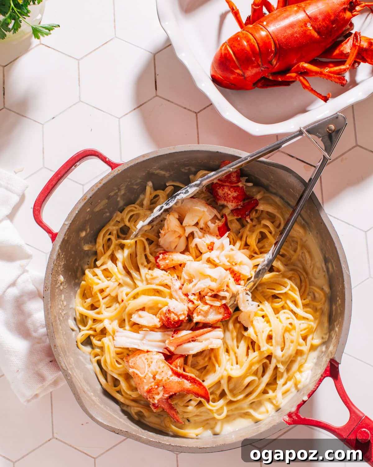 Luxurious Lobster Pasta with White Wine Cream Sauce 6 Finished Lobster Pasta served in a large pan with a serving spoon, highlighting its creamy texture and rich color.