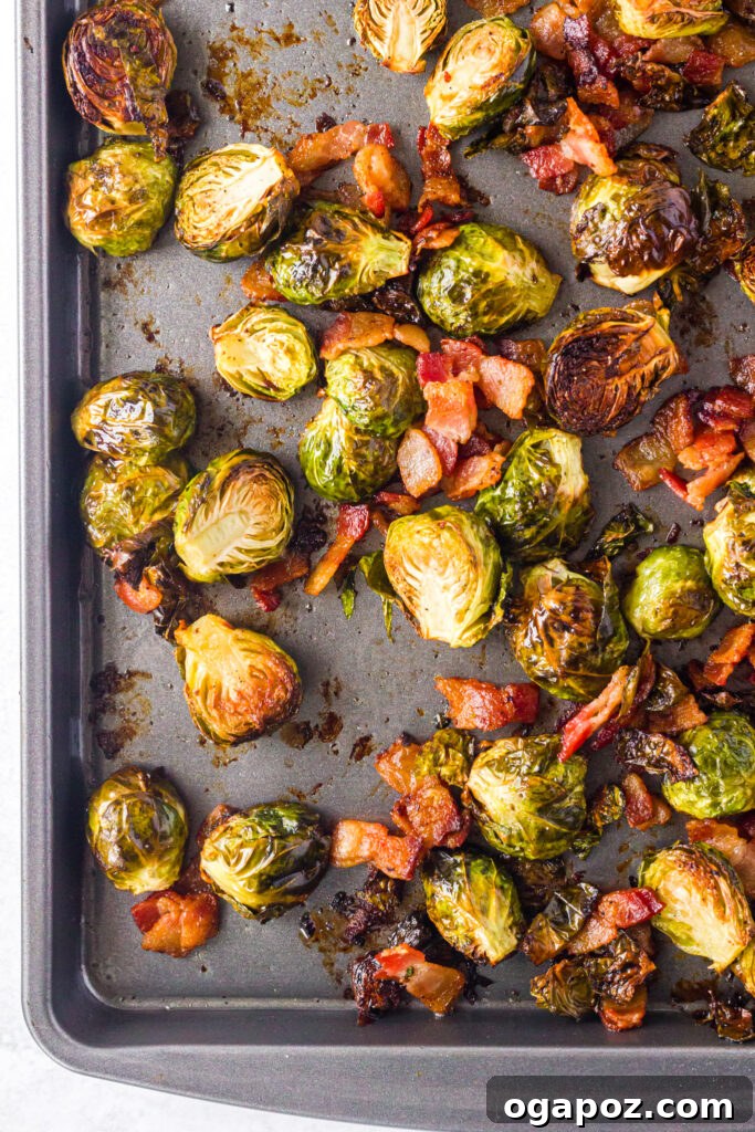 Roasted Brussels Sprouts and Bacon Delight 9 Crispy Roasted Brussels Sprouts with Bacon spread on a baking tray, fresh from the oven