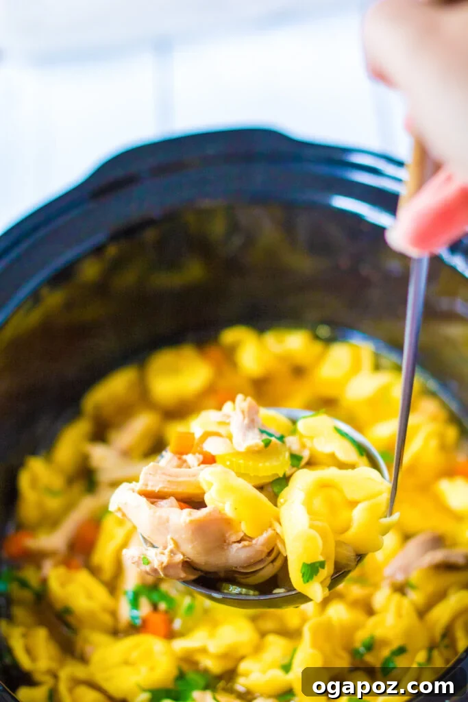 Chicken Tortellini Soup in a slow cooker with cooked tortellini