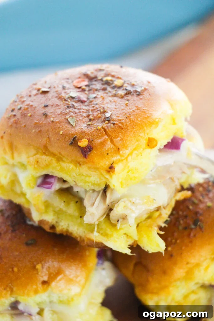 Effortless Chicken Sliders 2 A tray of golden-brown Easy Chicken Sliders arranged on a cutting board, garnished with fresh herbs, ready to be served for a party or game day
