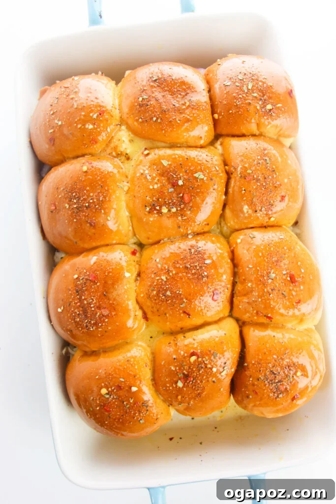 Effortless Chicken Sliders 12 Easy Chicken Sliders with the butter-Dijon sauce and spice mixture applied, ready for baking.