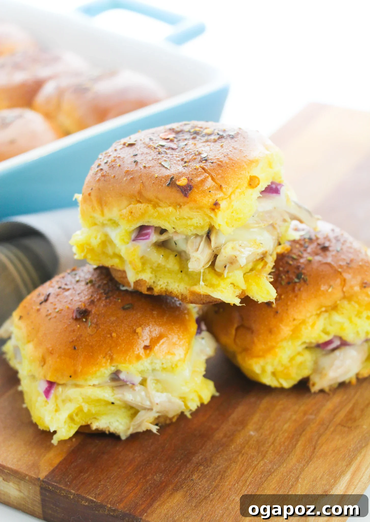 Effortless Chicken Sliders 13 Stack of freshly baked Easy Chicken Sliders, cut into individual portions and ready to serve.