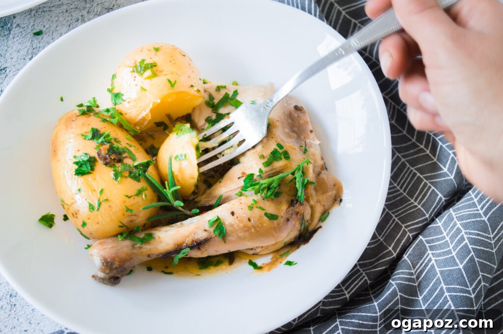 Golden Roasted Chicken with Crispy Herb Potatoes 7 Carved whole roasted chicken with fork and knife, served on a white platter with roasted potatoes and herbs