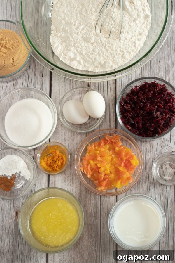 Sweet and Tart Cranberry Loaf 3 A collection of fresh ingredients for Cranberry Orange Bread, including vibrant cranberries, fresh oranges, flour, and baking essentials.
