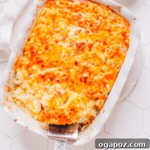 Effortless Comfort Chicken Potato Bake 7 A scoop being taken from a finished chicken potato casserole, showing the creamy texture and golden topping.